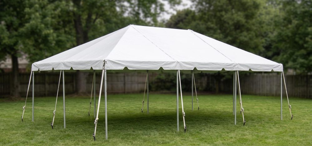 20 by 30 white frame tent on grass, staked, daylight